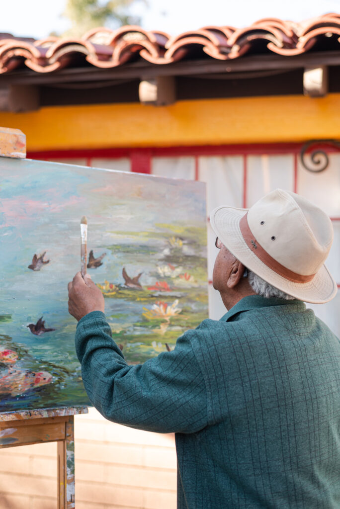 Edward Juarez painting in his studio